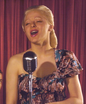 Singer performing with an early microphone